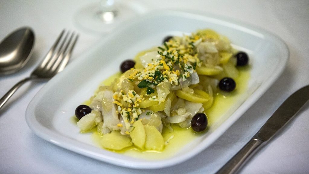 A traditional Portuguese dish called 'Bacalhau à Gomes de Sá' with cod, potatoes, and onions.