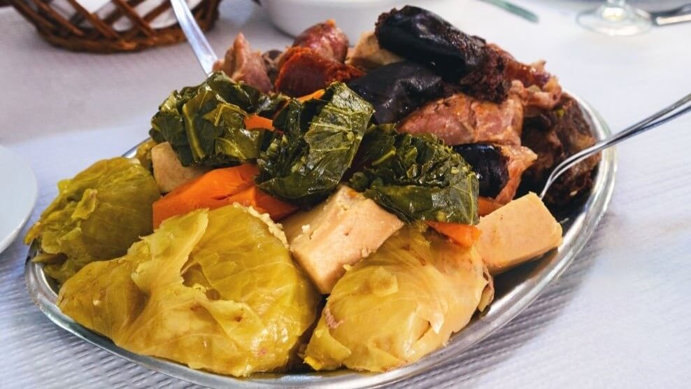 A platter of 'Cozido à Portuguesa,' a Portuguese stew with various meats and vegetables.